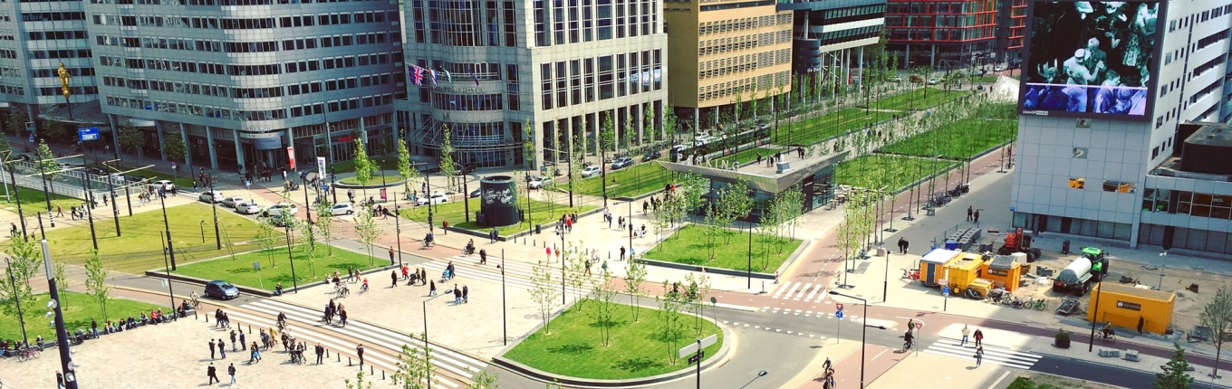 Mensen wandelen op plein voor Rotterdam Centraal Station